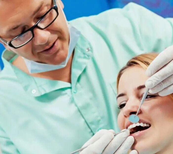 Orthodontist examining a patient’s teeth during an appointment in Granite Bay, CA